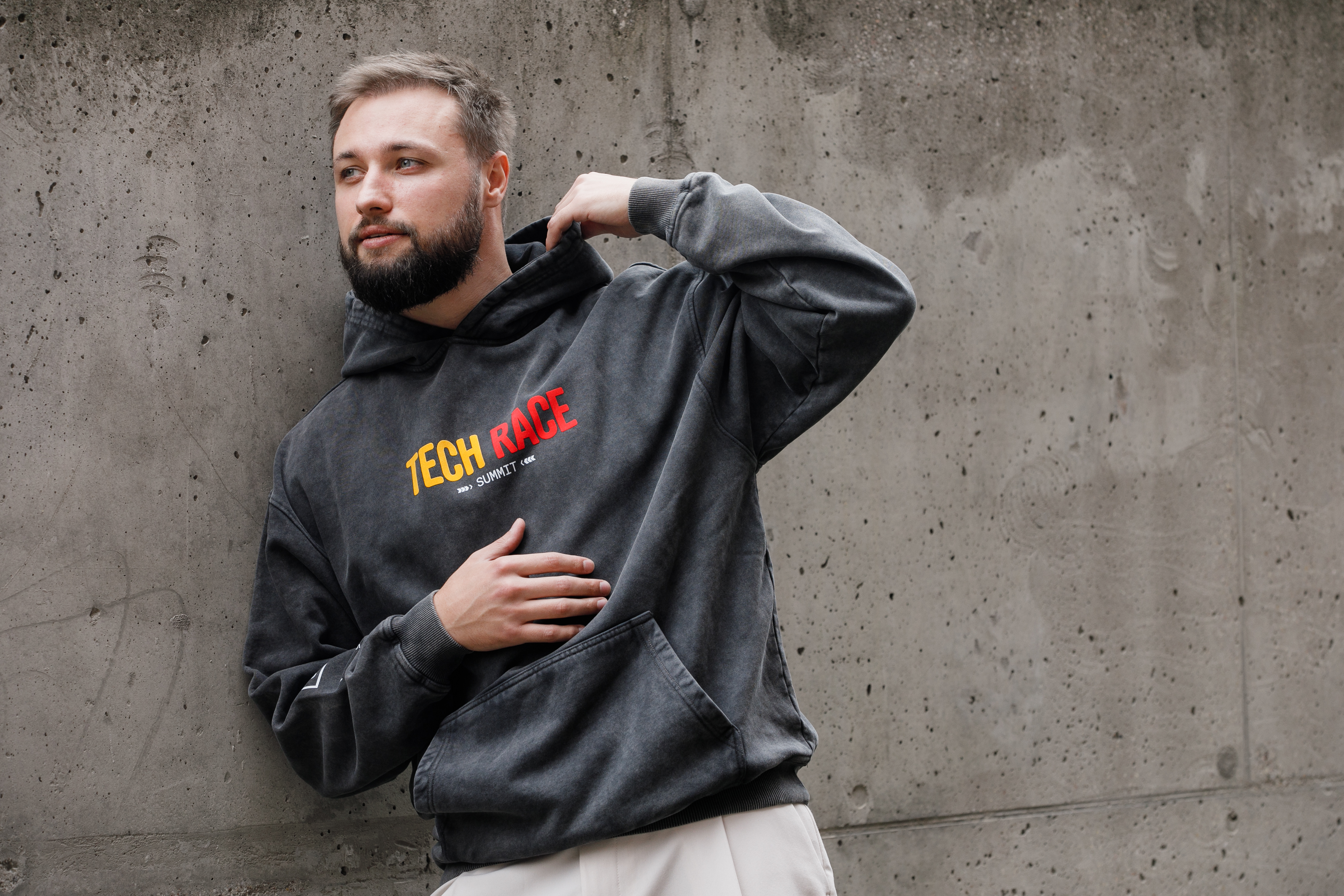 Model wearing the grey Tech Race Summit hoodie customised by Swag42 for SOFTSWISS