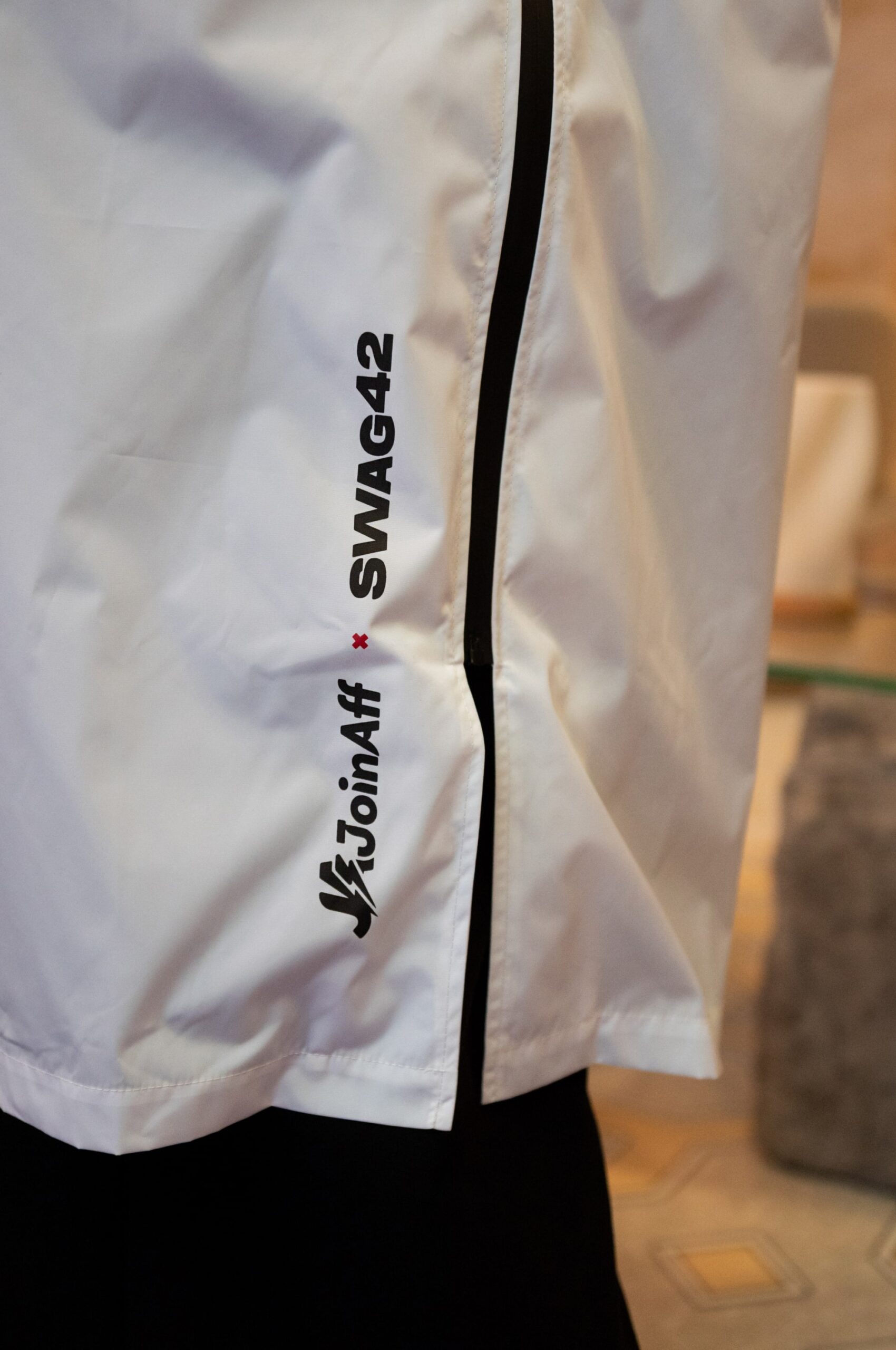 Waterproof white raincoat with a zip closure and custom branding