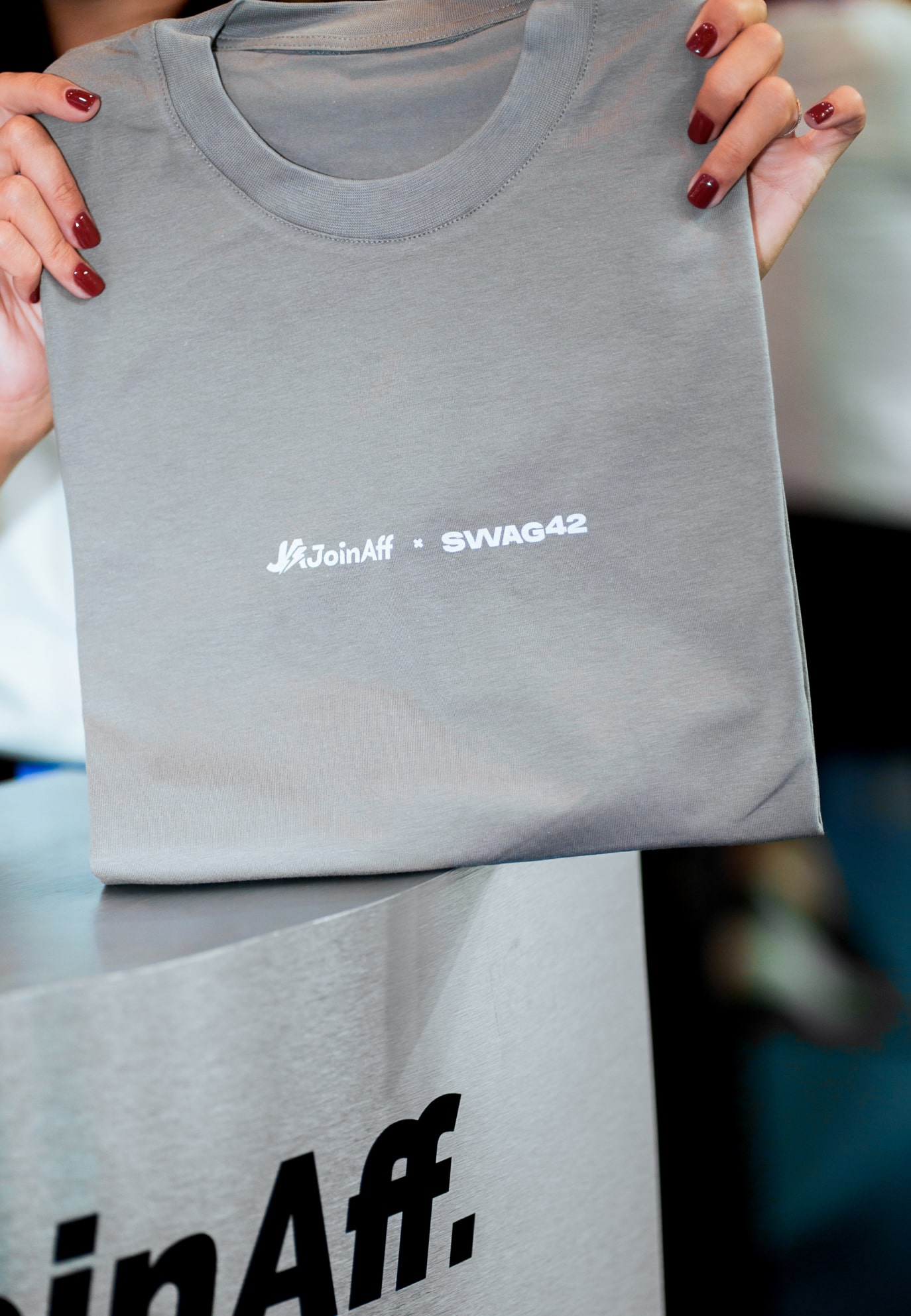 Customized grey T-shirt with logo for event merchandise. 
